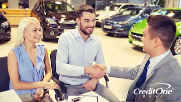 Couple with good credit closing the deal on a brand new car at a car dealership